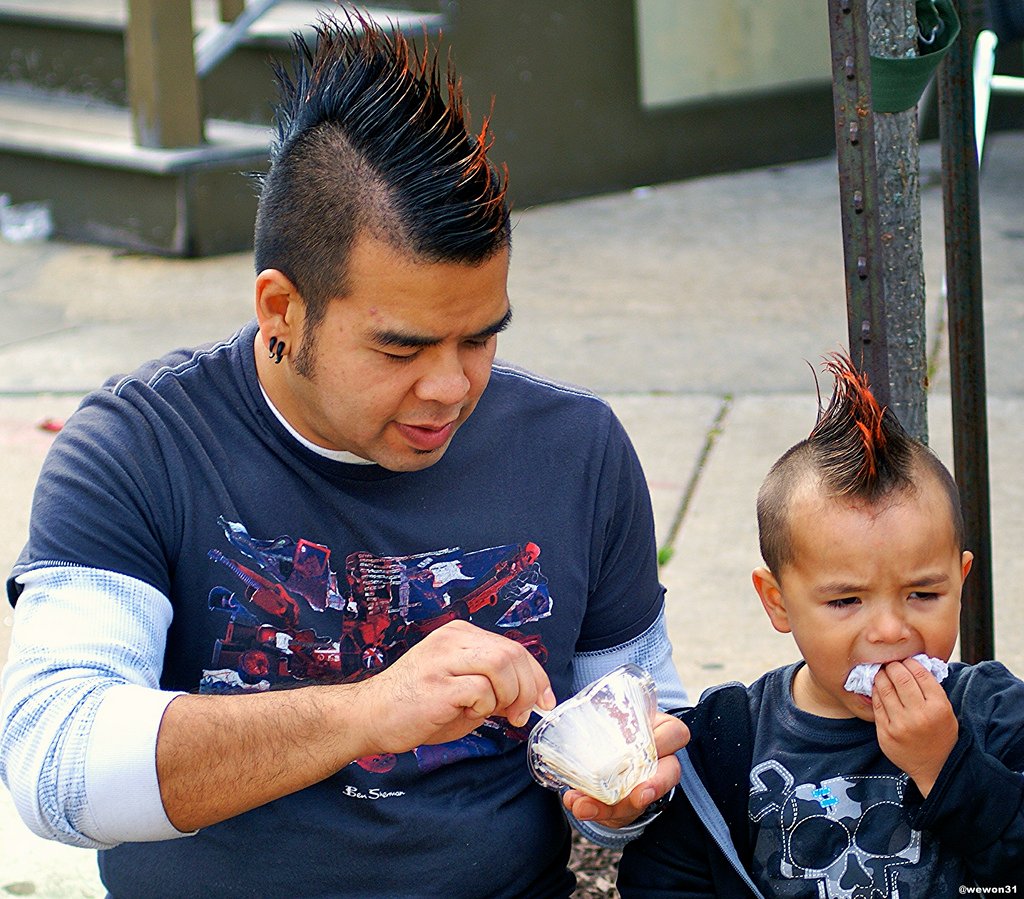 father and son with spiked black and orange mohawk