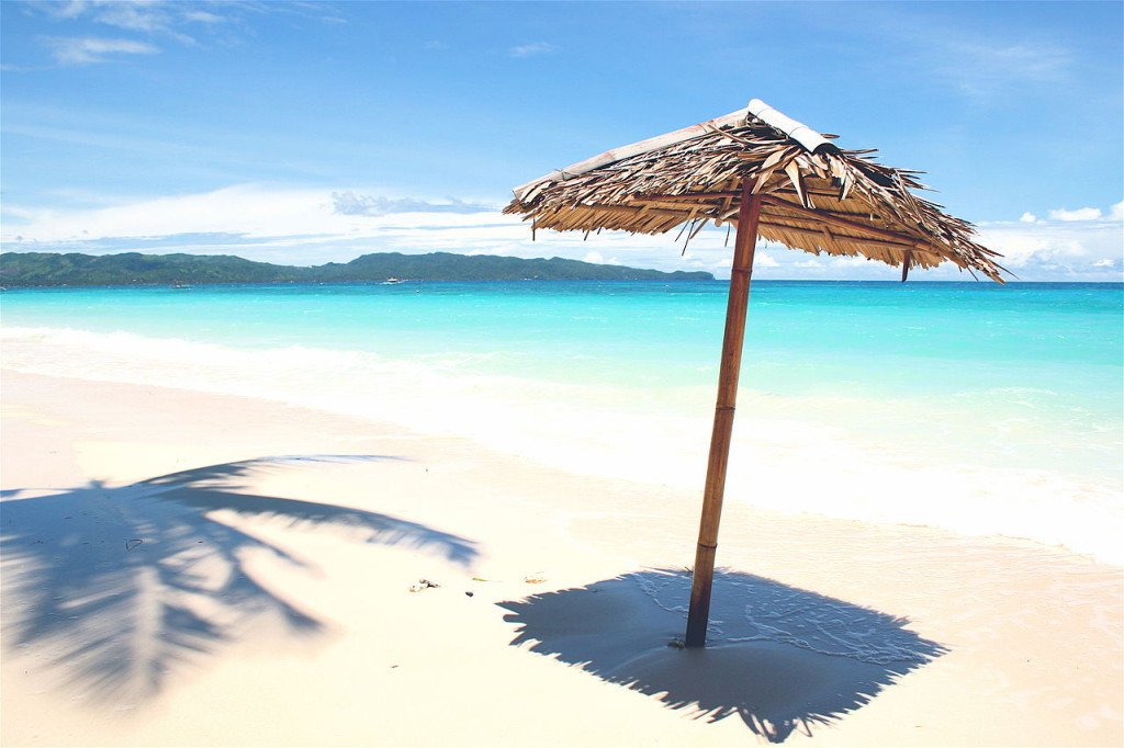 bamboo reed umbrella on a beach looking at to ocean