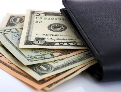 cash sticking out of wallet