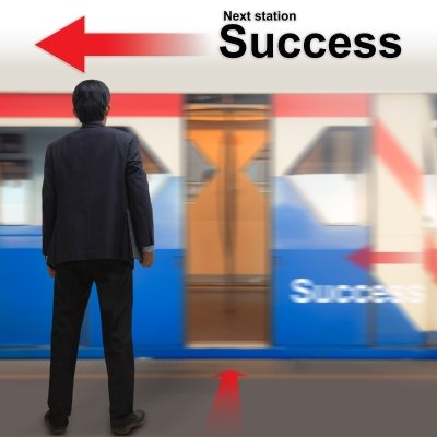 Man standing at train station,  success
