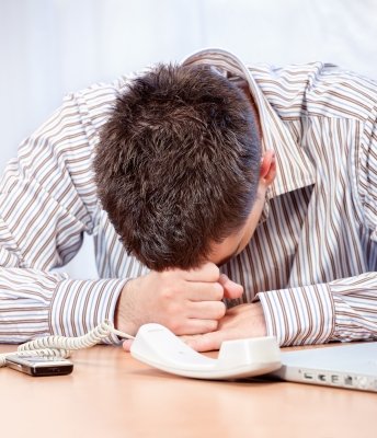 man with head down on desk