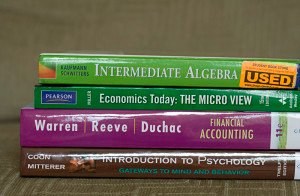 stack of four college textbooks