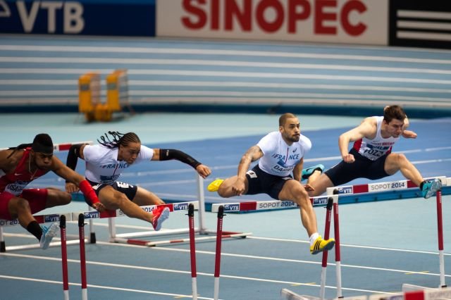sprinters jumping hurdles