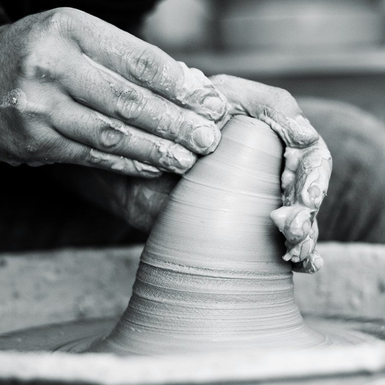 hands forming clay
